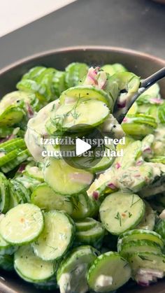 cucumber salad in a bowl with a spoon