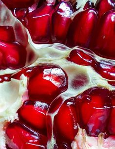 a close up view of the inside of a pomegranate that is red and white