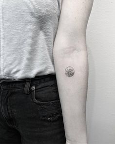 a person with a small tattoo on their arm