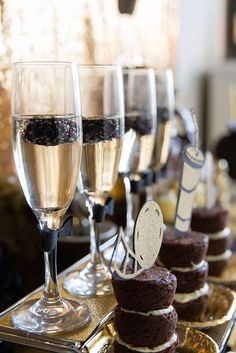 several desserts and glasses of wine on a table