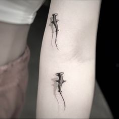 two small tattoos on the legs of people's legs, one is black and white