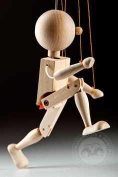 a wooden toy running with strings attached to it