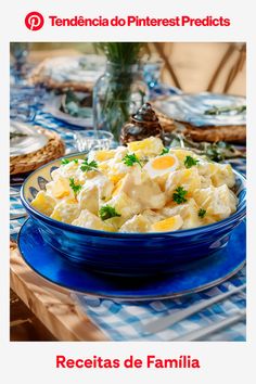 a blue bowl filled with food on top of a table