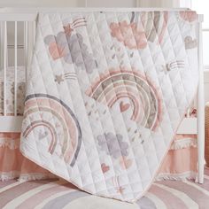 a baby crib with a pink and white blanket