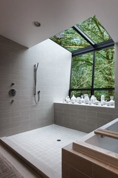 a large bathroom with a skylight above the bathtub and shower area is shown