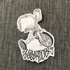 a sticker with the word anarchy on it and an image of a tricycle