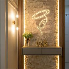 a bathroom with a brick wall and lighted artwork on the wall, along with a sink