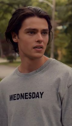 the young man is wearing a wednesday t - shirt