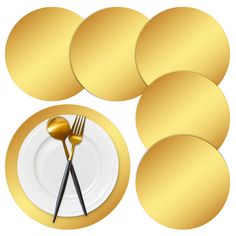 a set of four gold plates with forks and spoons