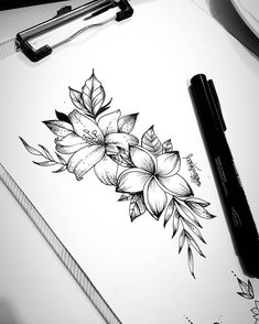 black and white drawing of flowers on top of a paper with pen next to it