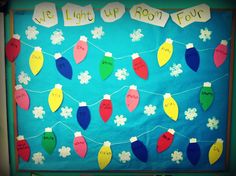 a bulletin board decorated with christmas lights and snowflakes on blue paper that says we light up boot four