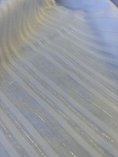 a close up view of a mattress that has been made into a bed frame with white lines on it