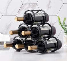 a stack of wine bottles sitting on top of a table