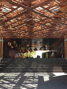 the inside of a building with wooden slats on the ceiling and steps leading up to it