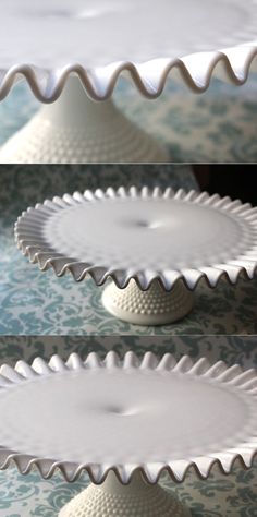 three white cake plates sitting on top of a table