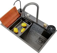 a kitchen sink with two yellow apples in it