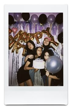 a group of people standing next to each other in front of balloons