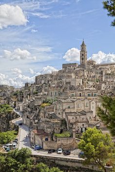 an old city with many buildings on the top and cars parked in the street below