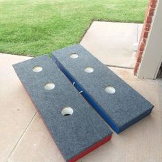 two blue and red pieces of cloth sitting on the ground next to a door with holes in it