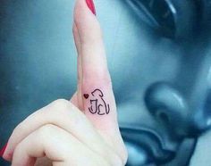 a woman's finger with a small elephant tattoo on it, and the word love is written in black ink