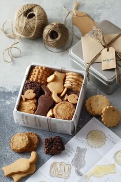 a tin filled with cookies and crackers on top of a table