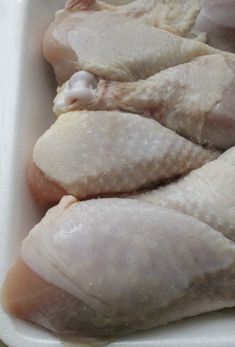 raw chicken pieces in a white container ready to be cooked