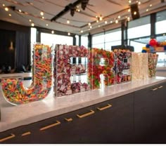 the letters are made out of candy and candies on top of a countertop