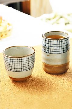 Bring timeless elegance to every sip with Eastern-inspired tea cups crafted from high-quality ceramic. Their clean lines and versatile design suit everything from tea ceremonies to coffee breaks, accommodating beverages like sake or whiskey. Adorned with blue checkered patterns on a white ceramic base, these cups feature a lustrous, easy-to-clean glaze. Whether gracing your workspace or as a thoughtful gift, they combine culture, function, and minimalist charm for an elevated sipping experience.