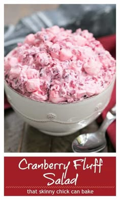 cranberry fluff salad in a white bowl with spoons on the side