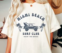 Miami Beach Surf Club Beach Tee Shirt Unisex Florida Tshirt Gift The Comfort Colors C1717 100% Ring Spun Cotton T-Shirt is very appropriately-named. All colors are inspired by nature and have a perfect lived-in, weathered look. Shirts are sent through a unique dyeing process that makes them incredibly soft and long-lasting. Each piece is soft-washed 50 times before making its way to you! Stitched at the collar, armhole, sleeves and bottom hem for ultimate durability, you will notice the density and quality of this shirt, but won't mind living in it. COMFORT COLORS 1717 ADULT TEE 6.1 Oz/SqYd 100% Ring Spun Cotton Soft-washed garment-dyed fabric Double-needle collar Twill taped neck and shoulders Twill label Relaxed fit Double needle armhole, sleeve and bottom hems Tubular body PROPER SIZING Beach Tshirt Designs, Florida Tshirt, Surf Club, Surf Tee, Beach Tee, Surf Tshirt, Beach Surf, Beach T Shirts, Dyeing Process