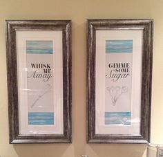 two framed pictures hang above a sink in a bathroom