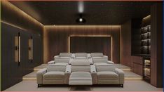 an empty theater room with recliners in it