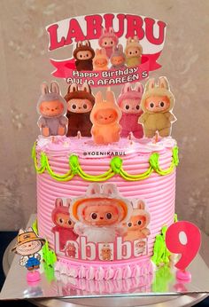 a pink birthday cake with little pigs on top and happy birthday to the baby girl