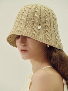 Marchen is a heritage mood fashion brand that not only stimulates the nostalgia of the older generation but also satisfies the new sensibilities of all generations by re-inventing the romantic design that the main characters in fairy tales would wear with a modern sensibility.- Attractive bucket hat with kitsch mood - Lovely heart symbol point- Sophisticated cable knitting detail- Great to block sunlight Vintage Winter Bucket Hat With Curved Brim, Winter Vintage Bucket Hat With Curved Brim, Vintage Wide Brim Winter Bucket Hat, Vintage Beige Bucket Hat With Short Brim, Vintage Beige Wide Brim Bucket Hat, Vintage Beige Hat For Winter, Vintage Bucket Hat For Beach, Vintage Beige Bucket Hat With Curved Brim, Vintage Beige Brimmed Bucket Hat