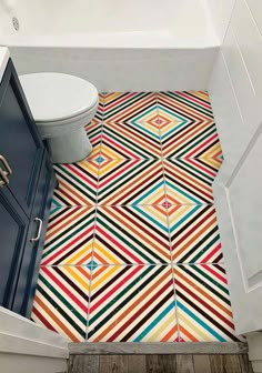 a bathroom with colorful tiles on the floor