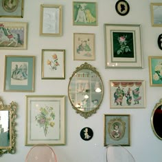 there are many framed pictures on the wall