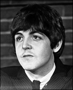 a black and white photo of a man in a suit with his eyes wide open