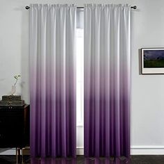 purple and white ombreed curtains hanging in front of a window