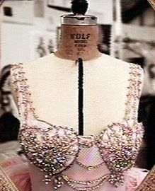 a mannequin is dressed up in pink and gold with sequins on it