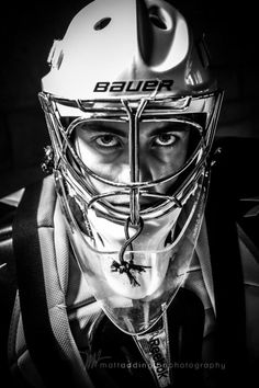 black and white photograph of a hockey player wearing a helmet