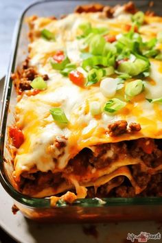 a casserole dish with meat, cheese and green onions in it on a plate