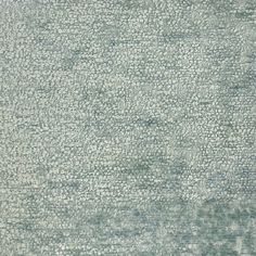 an area rug is shown in shades of blue and green, with small dots on the ground