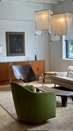 a living room filled with lots of furniture and lamps hanging from the ceiling next to a window