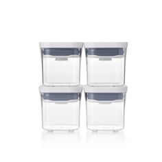 four clear storage containers with blue lids on each side and one empty container in the middle