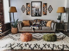 a living room filled with lots of furniture and pictures on the wall above it's couch