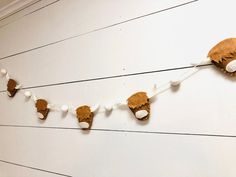 a string of stuffed animals hanging on the wall