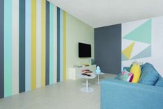 a living room filled with furniture and colorful striped walls