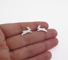 Unique and delicate bunny earrings, sterling silver studs for animal lovers.Minimalist, handmade jewelry for women.Beautiful and cute jumping rabbits stud earrings. These unique earrings are 100% handmade by me. I saw the rabbit figures by hand from a durable, solid sterling silver sheet, file it, solder the silver posts, and give them a matte or shiny finish.These minimalist earrings will compliment women of all ages. They can make a great gift for animal lovers and will become an instant favor Bunny Earring, Rabbit Earrings, Unique Handmade Earrings, Bunny Earrings, Silver Cat, Animal Earrings, Small Earrings Studs, Butterfly Jewelry, Earrings Unique