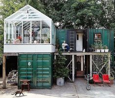 a house made out of shipping containers is shown