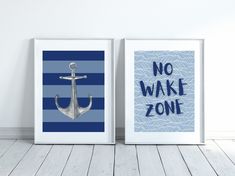 two framed posters with an anchor and the words no wake zone are displayed in front of a white wall